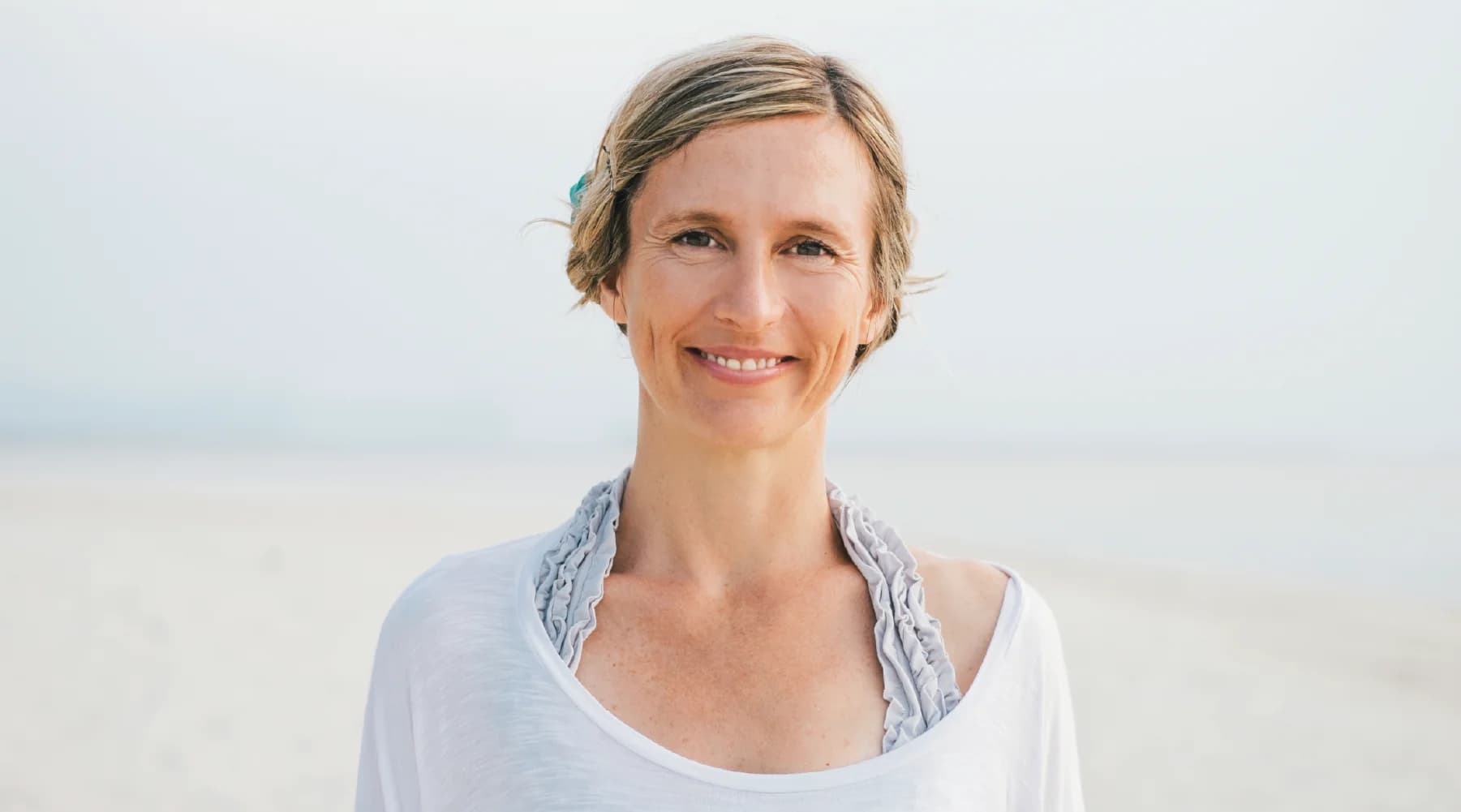 Black-and-white portrait of Lorraine Taylor, Teacher Training behind lorrainetayloryoga.com